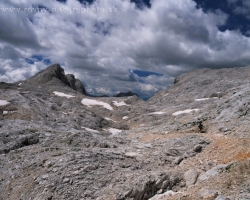 Contrast of desert rock and sky on the crest of the Julian Alps