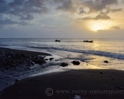 The setting sun turns the fishing boats to the villages.