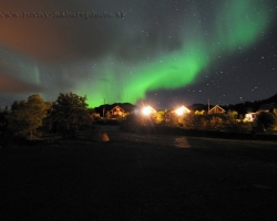 This image is a photo shoot away from the fjord over the village. Tinted red light lamps supplemented by numerous cases floating green aurora borealis. Shapes in the sky is brilliantly about change and not create two identical view. Feelings of this theater are amazing.