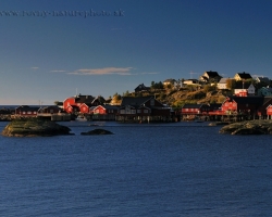 Fishing village on the furthest corner of the Lofoten with typical color contrast of cottages and ocean